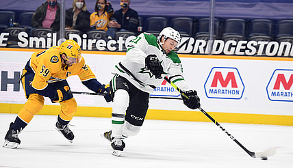 Mar 30, 2021; Nashville, Tennessee, USA; Dallas Stars left wing Jason Robertson (21) scores against Nashville Predators defenseman Roman Josi (59) during the second period at Bridgestone Arena. Mandatory Credit: Christopher Hanewinckel-USA TODAY Sports