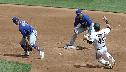 Apr 11, 2021; Pittsburgh, Pennsylvania, USA;  Chicago Cubs second baseman Eric Sogard (4) flips the ball between his legs to shortstop Javier Baez (9) for a forceout of Pittsburgh Pirates center fielder Dustin Fowler (49) at second base during the third inning at PNC Park. Mandatory Credit: Charles LeClaire-USA TODAY Sports