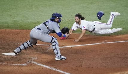 Sep 10, 2022; Arlington, Texas, USA; Texas Rangers third baseman Josh Smith (47) dives into home plate as Toronto Blue Jays catcher Danny Jansen (9) awaits the throw during the sixth inning at Globe Life Field. Mandatory Credit: Raymond Carlin III-USA TODAY Sports