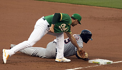 Apr 16, 2021; Oakland, California, USA; Detroit Tigers baserunner Willi Castro (9) beats a snap pickoff throw to Oakland Athletics first baseman Matt Olson during the first inning of a Major League Baseball game at RingCentral Coliseum. Mandatory Credit: D. Ross Cameron-USA TODAY Sports
