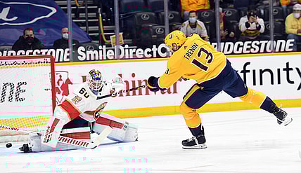 Apr 26, 2021; Nashville, Tennessee, USA; Nashville Predators center Yakov Trenin (13) shoots wide of Florida Panthers goaltender Chris Driedger (60) during the first period at Bridgestone Arena. Mandatory Credit: Christopher Hanewinckel-USA TODAY Sports