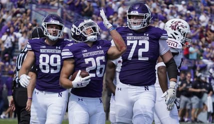 Sep 17, 2022; Evanston, Illinois, USA; Northwestern Wildcats running back Evan Hull (26) celebrates after scoring a touchdown against the Southern Illinois Salukis during the first half at Ryan Field. Mandatory Credit: David Banks-USA TODAY Sports