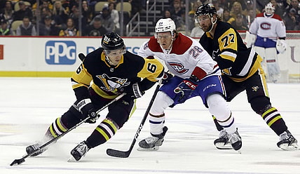 Nov 27, 2021; Pittsburgh, Pennsylvania, USA; Pittsburgh Penguins defenseman John Marino (6) handles the puck against Montreal Canadiens center Christian Dvorak (28) during the first period at PPG Paints Arena. Mandatory Credit: Charles LeClaire-USA TODAY Sports