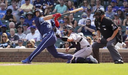 Sep 16, 2022; Chicago, Illinois, USA; Chicago Cubs third baseman David Bote (13) hits a single against the Colorado Rockies during the first inning at Wrigley Field. Mandatory Credit: David Banks-USA TODAY Sports
