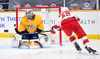 Jan 18, 2021; Nashville, Tennessee, USA; Nashville Predators goaltender Pekka Rinne (35) makes a save on a shot by Carolina Hurricanes left wing Jordan Martinook (48) during the second period at Bridgestone Arena. Mandatory Credit: Christopher Hanewinckel-USA TODAY Sports