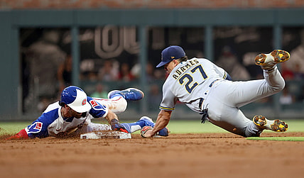 Jul 30, 2021; Atlanta, Georgia, USA; Atlanta Braves shortstop Dansby Swanson (7) steals second base ahead of the tag by Milwaukee Brewers shortstop Willy Adames (27) during the first inning at Truist Park. Mandatory Credit: Jason Getz-USA TODAY Sports