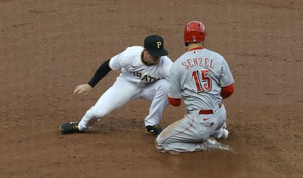 May 11, 2021; Pittsburgh, Pennsylvania, USA; Pittsburgh Pirates shortstop Kevin Newman (L) tags out Cincinnati Reds second baseman Nick Senzel (15) attempting to steal second base during the third inning at PNC Park. Mandatory Credit: Charles LeClaire-USA TODAY Sports