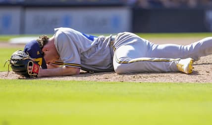 Apr 15, 2023; San Diego, California, USA;  Milwaukee Brewers relief pitcher Gus Varland lies on the ground after being hit by a line out by San Diego Padres third baseman Manny Machado (not pictured) during the eighth inningat Petco Park. Mandatory Credit: Ray Acevedo-USA TODAY Sports
