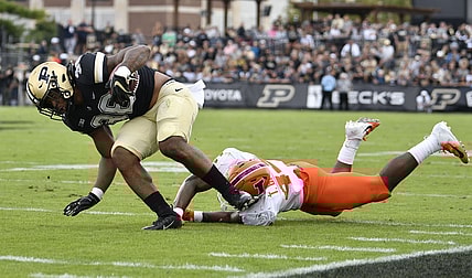 Sep 25, 2021; West Lafayette, Indiana, USA;  Purdue Boilermakers running back Dylan Downing (38) evades a tackle against Illinois Fighting Illini linebacker Tarique Barnes (44) during the first quarter at Ross-Ade Stadium. Mandatory Credit: Marc Lebryk-USA TODAY Sports