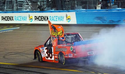 Nov 4, 2022; Avondale, Arizona, USA; Camping World Truck Series driver Zane Smith (38) celebrates winning the Truck Series Championship at Phoenix Raceway. Mandatory Credit: John David Mercer-USA TODAY Sports