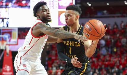Mar 2, 2023; Houston, Texas, USA; Wichita State Shockers guard Xavier Bell (1) controls the ball as Houston Cougars guard Jamal Shead (1) defends during the first half at Fertitta Center. Mandatory Credit: Troy Taormina-USA TODAY Sports