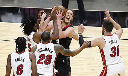 Apr 19, 2021; Miami, Florida, USA;  Houston Rockets forward Kelly Olynyk (41) is defended by Miami Heat players forward Precious Achiuwa (5), forward Trevor Arizam guard Andre Iguodada and guard Max Straus (31) during the first half at American Airlines Arena. Mandatory Credit: Rhona Wise-USA TODAY Sports