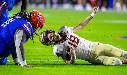 Florida Gators defensive lineman Desmond Watson (21) sacks Florida State Seminoles quarterback Tate Rodemaker (18) during second half action as Florida takes on Florida State at Steve Spurrier Field at Ben Hill Griffin Stadium in Gainesville, FL on Saturday, November 25, 2023. [Alan Youngblood/Gainesville Sun]