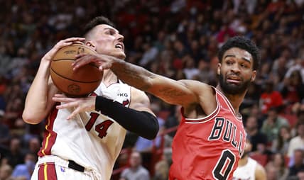 Feb 28, 2022; Miami, Florida, USA;  Miami Heat guard Tyler Herro (14) is fouled by Chicago Bulls guard Coby White (0) during the second half at FTX Arena. Mandatory Credit: Rhona Wise-USA TODAY Sports