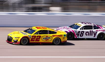 Sep 11, 2022; Kansas City, Kansas, USA; NASCAR Cup Series driver Joey Logano (22) leads driver Alex Bowman (48) during the Hollywood Casino 400 at Kansas Speedway. Mandatory Credit: Jay Biggerstaff-USA TODAY Sports