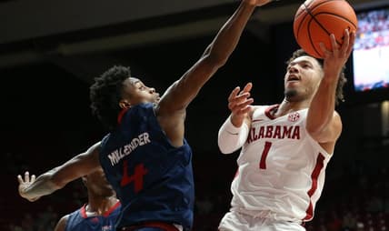 Nov 14, 2023; Tuscaloosa, Alabama, USA;  South Alabama guard Marcus Millender (4) guards a shot by Alabama guard Mark Sears (1) in the lane at Coleman Coliseum. Mandatory Credit: Gary Cosby Jr.-USA TODAY Sports