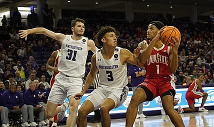 Jan 1, 2023; Evanston, Illinois, USA; Northwestern Wildcats guard Ty Berry (3) defends Ohio State Buckeyes guard Roddy Gayle Jr. (1) during the first half at Welsh-Ryan Arena. Mandatory Credit: David Banks-USA TODAY Sports