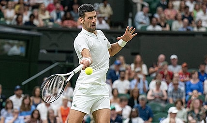 Jul 7, 2023; London, United Kingdom; Novak Djokovic (SRB) returns a shot during his match against Stanislas Wawrinka (SUI) on day five of Wimbledon at the All England Lawn Tennis and Croquet Club.  Mandatory Credit: Susan Mullane-USA TODAY Sports