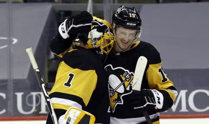 Mar 25, 2021; Pittsburgh, Pennsylvania, USA;  Pittsburgh Penguins goaltender Casey DeSmith (1) and center Jared McCann (19) celebrate after defeating the Buffalo Sabres at PPG Paints Arena. The Penguins shutout the Sabres 4-0. Mandatory Credit: Charles LeClaire-USA TODAY Sports