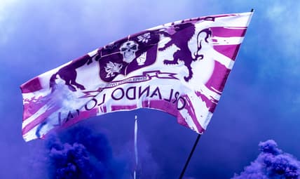 Mar 31, 2019; Orlando, FL, USA; General view of Orlando City fans waving a flag while marching to the stadium prior to the game between the Orlando City and the D.C. United at Orlando City Stadium. Mandatory Credit: Douglas DeFelice-USA TODAY Sports