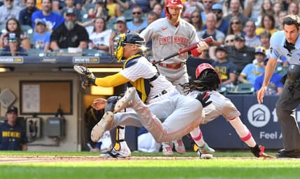 Jul 8, 2023; Milwaukee, Wisconsin, USA; Cincinnati Reds shortstop Elly De La Cruz (44) slides safely into home ahead of the tag by Milwaukee Brewers catcher William Contreras (24) in the seventh inning at American Family Field. Mandatory Credit: Michael McLoone-USA TODAY Sports