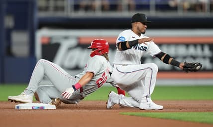 Jul 31, 2023; Miami, Florida, USA; Philadelphia Phillies first baseman Alec Bohm (28) steals second base as Miami Marlins second baseman Luis Arraez (3) gathers the ball in the first inning at loanDepot Park. Mandatory Credit: Jim Rassol-USA TODAY Sports