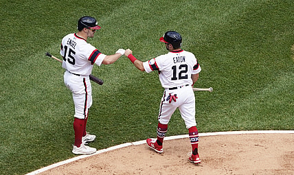 Jun 6, 2021; Chicago, Illinois, USA; Chicago White Sox right fielder Adam Eaton (12) is greeted by center fielder Adam Engel (15) after scoring against the Detroit Tigers during the second inning at Guaranteed Rate Field. Mandatory Credit: David Banks-USA TODAY Sports