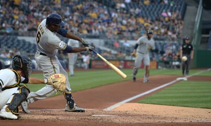 Jul 28, 2021; Pittsburgh, Pennsylvania, USA; Milwaukee Brewers center fielder Lorenzo Cain (6) hits a two run single against the Pittsburgh Pirates during the fourth inning at PNC Park. Mandatory Credit: Charles LeClaire-USA TODAY Sports