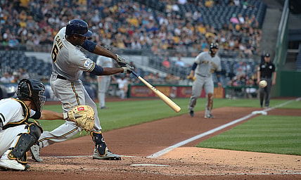 Jul 28, 2021; Pittsburgh, Pennsylvania, USA; Milwaukee Brewers center fielder Lorenzo Cain (6) hits a two run single against the Pittsburgh Pirates during the fourth inning at PNC Park. Mandatory Credit: Charles LeClaire-USA TODAY Sports