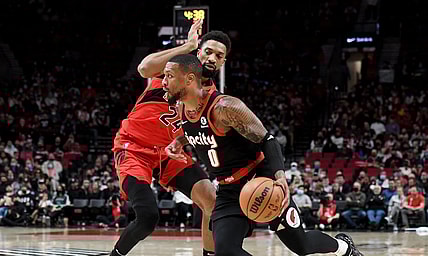 Nov 15, 2021; Portland, Oregon, USA; Portland Trail Blazers guard Damian Lillard (0) drives to the basket on Portland Trail Blazers forward Norman Powell (24) during the first quarter  the game at Moda Center. Mandatory Credit: Steve Dykes-USA TODAY Sports