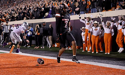 Oklahoma State's Cameron Epps (7) returns an interception for a touchdown in front of Kansas State's Hayden Gillum (55) in the first half of the college football game between the Oklahoma State University Cowboys and the Kansas State Wildcats at Boone Pickens Stadium in Stillwater. Okla., Friday, Oct. 6, 2023.