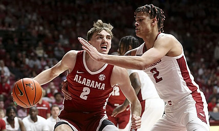 Mar 9, 2024; Tuscaloosa, Alabama, USA;  Alabama Crimson Tide forward Grant Nelson (2) drives against Arkansas Razorbacks forward Trevon Brazile (2) at Coleman Coliseum. Mandatory Credit: Gary Cosby Jr.-USA TODAY Sports