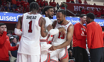 Mar 9, 2024; Houston, Texas, USA; Houston Cougars forward J'Wan Roberts (13) celebrates with guard Mylik Wilson (8) and guard Jamal Shead (1) in the final minute of the game against the Kansas Jayhawks at Fertitta Center. Mandatory Credit: Troy Taormina-USA TODAY Sports