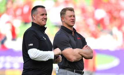 Aug 27, 2022; Dublin, IRELAND; Northwestern Wildcats head coach Pat Fitzgerald, left, and Nebraska Cornhuskers head coach Scott Frost on the field before the Aer Lingus college football series at Aviva Stadium. Mandatory Credit: Brendan Moran-USA TODAY Sports