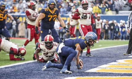 Nov 12, 2022; Morgantown, West Virginia, USA; West Virginia Mountaineers quarterback Garrett Greene (6) runs the ball for a touchdown during the second quarter against the Oklahoma Sooners at Mountaineer Field at Milan Puskar Stadium. Mandatory Credit: Ben Queen-USA TODAY Sports