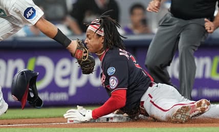 Aug 25, 2023; Miami, Florida, USA; Washington Nationals shortstop CJ Abrams (5) steals third base ahead of the tag by Miami Marlins third baseman Jake Burger (36) in the first inning at loanDepot Park. Mandatory Credit: Jim Rassol-USA TODAY Sports