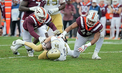 Nov 5, 2022; Blacksburg, Virginia, USA; Virginia Tech Hokies defensive lineman Jaylen Griffin (41) and Virginia Tech Hokies defensive lineman sack Virginia Tech Hokies defensive lineman TyJuan Garbutt (45) sack Georgia Tech Yellow Jackets quarterback Zach Pyron (14)  in the firsbhalf at Lane Stadium. Mandatory Credit: Lee Luther Jr.-USA TODAY Sports