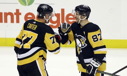 May 6, 2021; Pittsburgh, Pennsylvania, USA;  Pittsburgh Penguins center Jeff Carter (77) and center Sidney Crosby (87) celebrate after defeating the Buffalo Sabres at PPG Paints Arena. Pittsburgh won 8-4. Mandatory Credit: Charles LeClaire-USA TODAY Sports