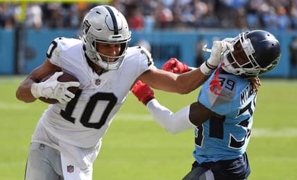 Sep 25, 2022; Nashville, Tennessee, USA; Las Vegas Raiders wide receiver Mack Hollins (10) pushes off on a tackle attempt by Tennessee Titans cornerback Terrance Mitchell (39) during the second half at Nissan Stadium. Mandatory Credit: Christopher Hanewinckel-USA TODAY Sports