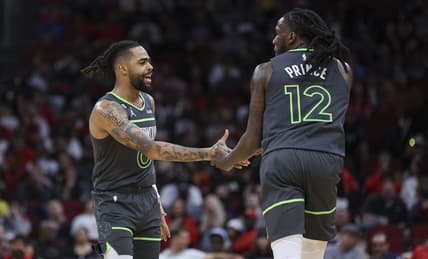 Jan 8, 2023; Houston, Texas, USA; Minnesota Timberwolves forward Taurean Prince (12) celebrates with guard D'Angelo Russell (0) after scoring a basket during the fourth quarter against the Houston Rockets at Toyota Center. Mandatory Credit: Troy Taormina-USA TODAY Sports