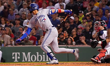 Aug 23, 2022; Boston, Massachusetts, USA; Toronto Blue Jays left fielder Lourdes Gurriel Jr. (13) hits a double to drive in a run against the Boston Red Sox in the third inning at Fenway Park. Mandatory Credit: David Butler II-USA TODAY Sports