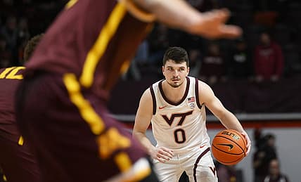 Nov 28, 2022; Blacksburg, Virginia, USA; Virginia Tech Hokies guard Hunter Cattoor (0) dribbles against the Minnesota Golden Gophers defense in the second half at Cassell Coliseum. Mandatory Credit: Lee Luther Jr.-USA TODAY Sports