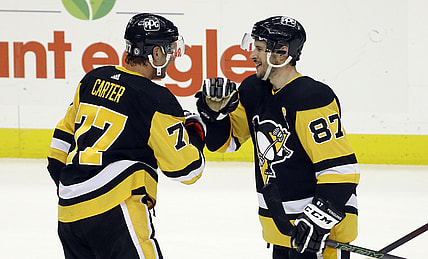 May 6, 2021; Pittsburgh, Pennsylvania, USA;  Pittsburgh Penguins center Jeff Carter (77) and center Sidney Crosby (87) celebrate after defeating the Buffalo Sabres at PPG Paints Arena. Pittsburgh won 8-4. Mandatory Credit: Charles LeClaire-USA TODAY Sports