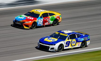 Sep 11, 2022; Kansas City, Kansas, USA; NASCAR Cup Series driver Chase Elliott (9) leads driver Kyle Busch (18) during the Hollywood Casino 400 at Kansas Speedway. Mandatory Credit: Jay Biggerstaff-USA TODAY Sports