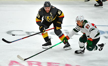 May 16, 2021; Las Vegas, Nevada, USA; Vegas Golden Knights right wing Mark Stone (61) tips the puck away from Minnesota Wild left wing Kirill Kaprizov (97) during the third period of game one of the first round of the 2021 Stanley Cup Playoffs at T-Mobile Arena. Mandatory Credit: Stephen R. Sylvanie-USA TODAY Sports