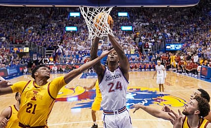 Jan 14, 2023; Lawrence, Kansas, USA; Kansas Jayhawks forward K.J. Adams Jr. (24) shoots as Iowa State Cyclones center Osun Osunniyi (21) defends during the second half at Allen Fieldhouse. Mandatory Credit: Denny Medley-USA TODAY Sports