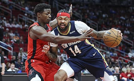 Mar 19, 2023; Houston, Texas, USA; New Orleans Pelicans forward Brandon Ingram (14) controls the ball as Houston Rockets forward Jae'Sean Tate (8) defends during the second quarter at Toyota Center. Mandatory Credit: Troy Taormina-USA TODAY Sports