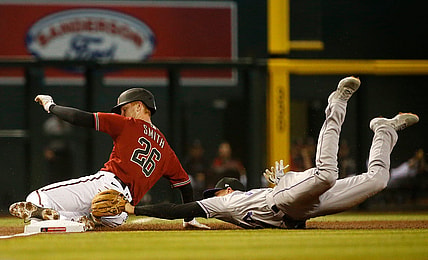 May 2, 2021; Phoenix, Arizona, USA; Rockies' Ryan McMahon (24) dives and tags out Diamondbacks' Pavin Smith (26) as he slides into third during the first inning at Chase Field. Patrick Breen-Arizona Republic

Mlb Rockies Vs Diamondbacks