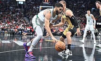 Nov 17, 2023; Toronto, Ontario, CAN;   Boston Celtics forward Jayson Tatum (0) dribbles the ball past Toronto Raptors guard Malachi Flynn (22) in the first half at Scotiabank Arena. Mandatory Credit: Dan Hamilton-USA TODAY Sports