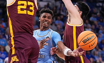 Indiana State Sycamores guard Julian Larry (1) passes the ball against Minnesota Golden Gophers forward Dawson Garcia (3) and Minnesota Golden Gophers forward Parker Fox (23) on Sunday, March 24, 2024, during the second round of the NIT at the Hulman Center in Terre Haute.